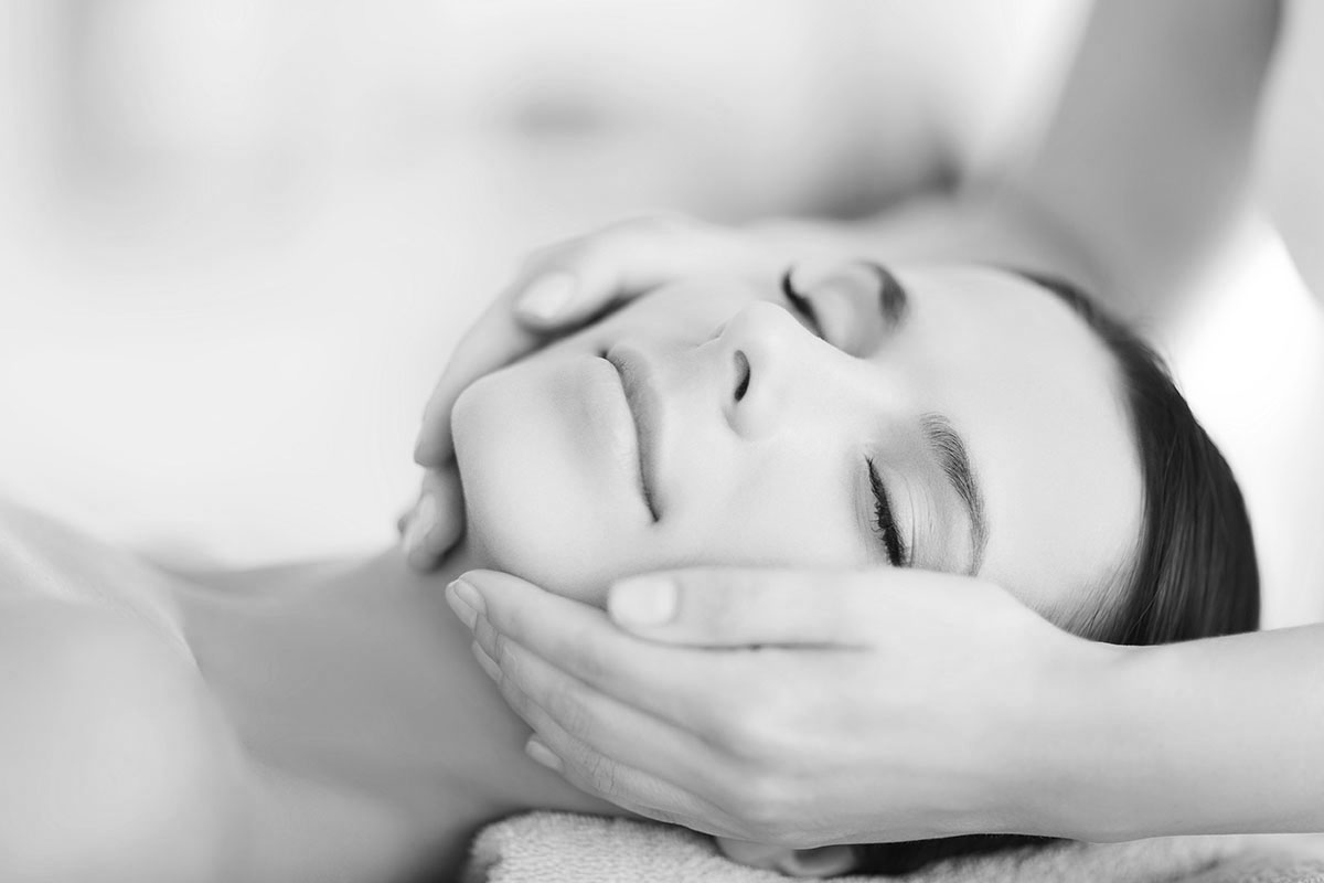 beautiful woman in spa salon having facial